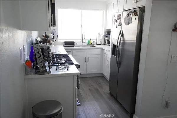 a kitchen with a white cabinets and white appliances