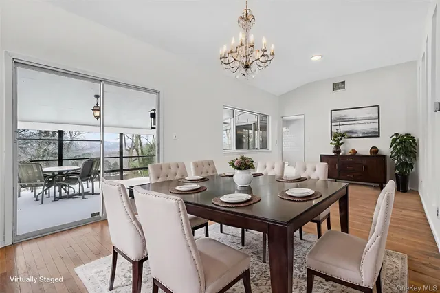 a dining room with furniture and wooden floor