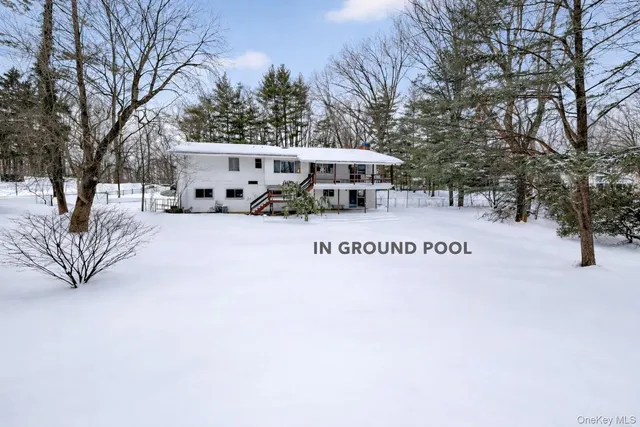 a view of a house with a yard covered in snow