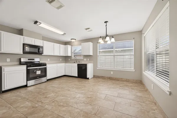 a kitchen with kitchen island a sink stainless steel appliances and cabinets