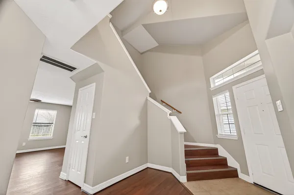a view of entryway with stairs and wooden floor
