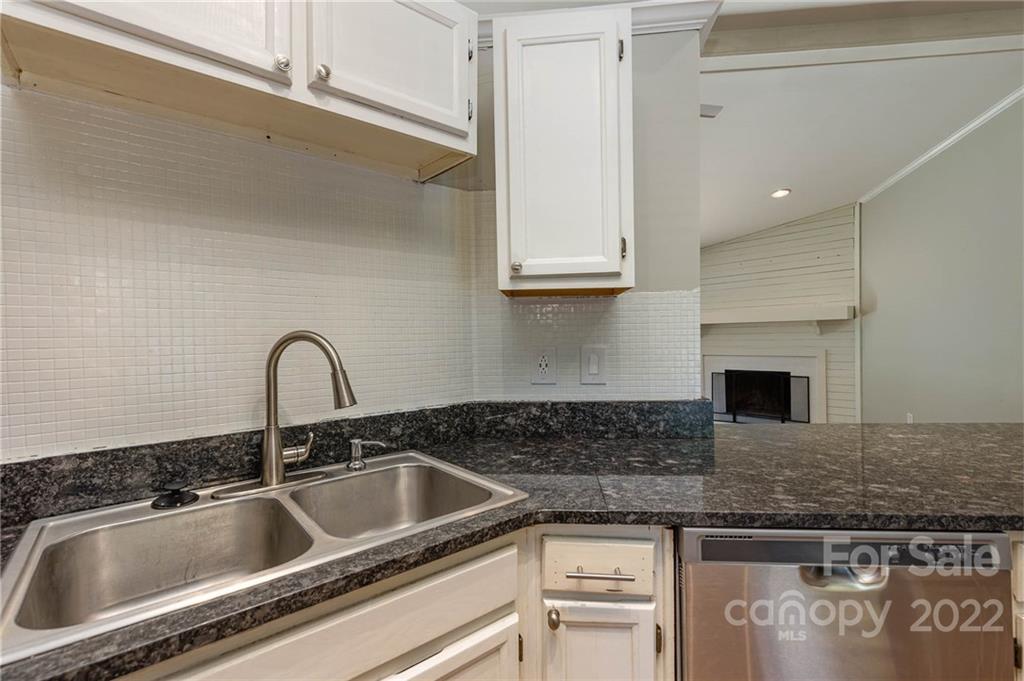 3415 Spring Terrace Lane Charlotte, NC 28269 - Photo 11 of 23 a kitchen with granite countertop a sink stainless steel appliances and cabinets