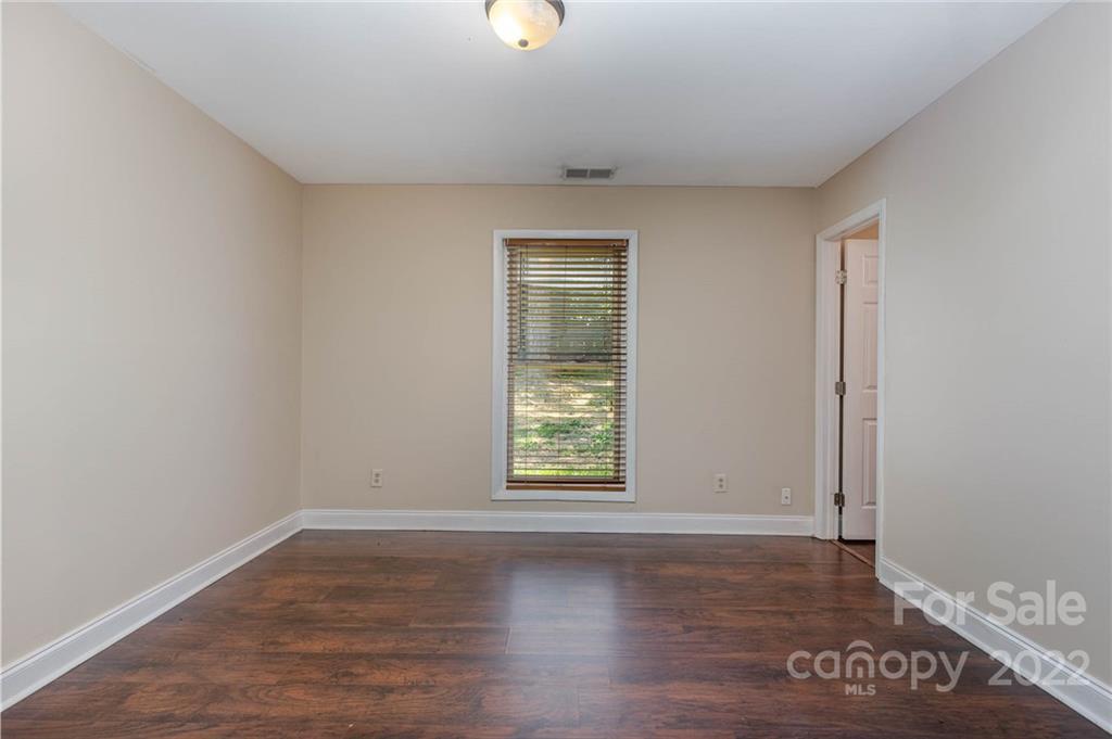 3415 Spring Terrace Lane Charlotte, NC 28269 - Photo 13 of 23 an empty room with wooden floor and windows