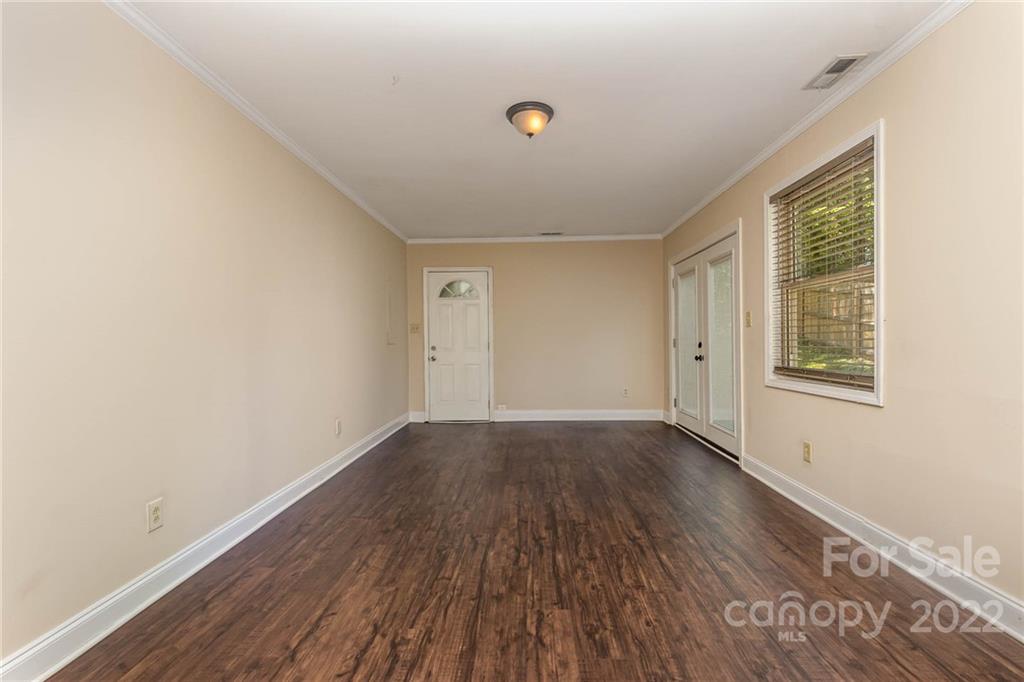 3415 Spring Terrace Lane Charlotte, NC 28269 - Photo 14 of 23 an empty room with wooden floor and windows
