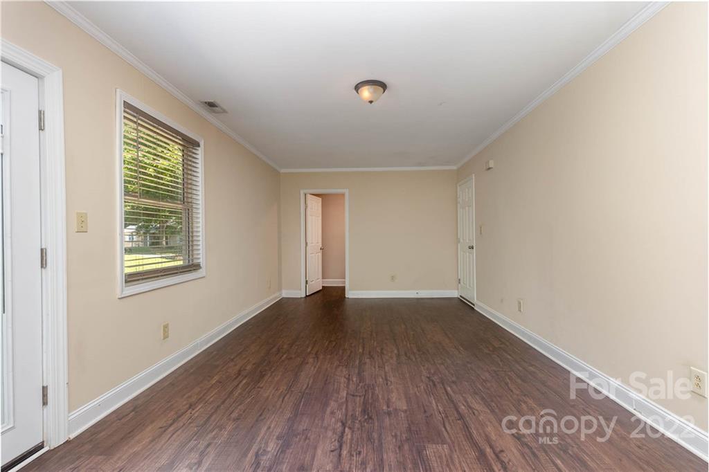 3415 Spring Terrace Lane Charlotte, NC 28269 - Photo 15 of 23 an empty room with wooden floor and windows