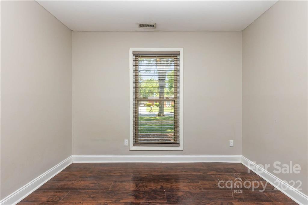 3415 Spring Terrace Lane Charlotte, NC 28269 - Photo 16 of 23 a view of an empty room with wooden floor and a window