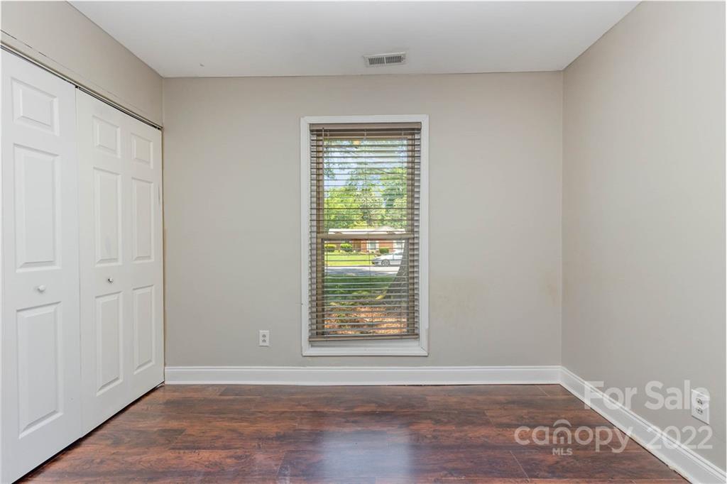 3415 Spring Terrace Lane Charlotte, NC 28269 - Photo 17 of 23 a view of an empty room with wooden floor and a window