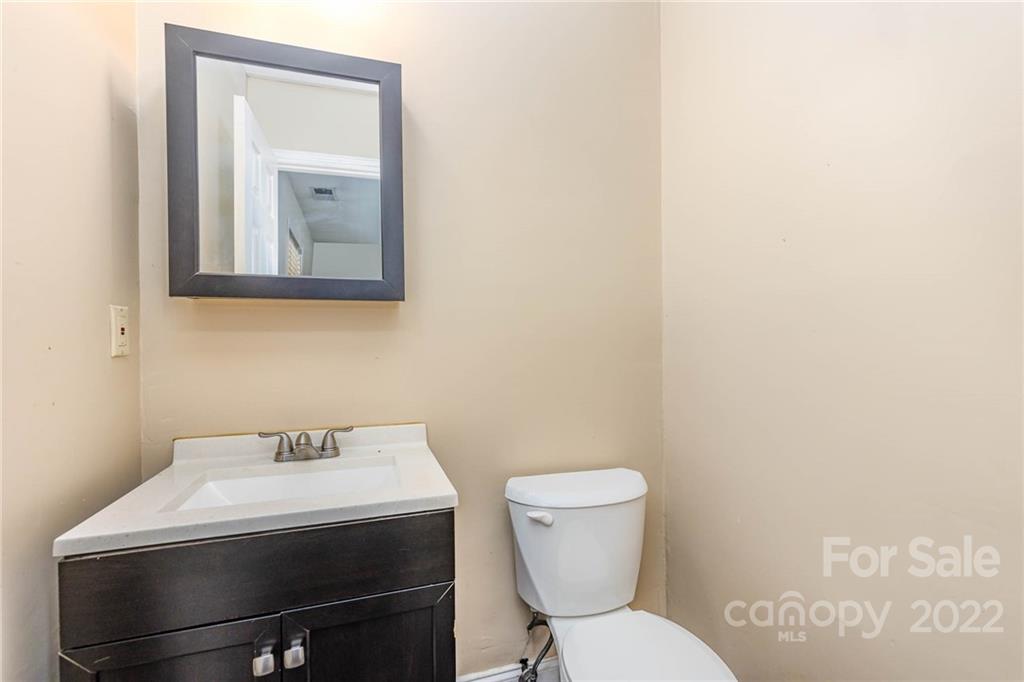 3415 Spring Terrace Lane Charlotte, NC 28269 - Photo 19 of 23 a bathroom with a toilet sink and mirror