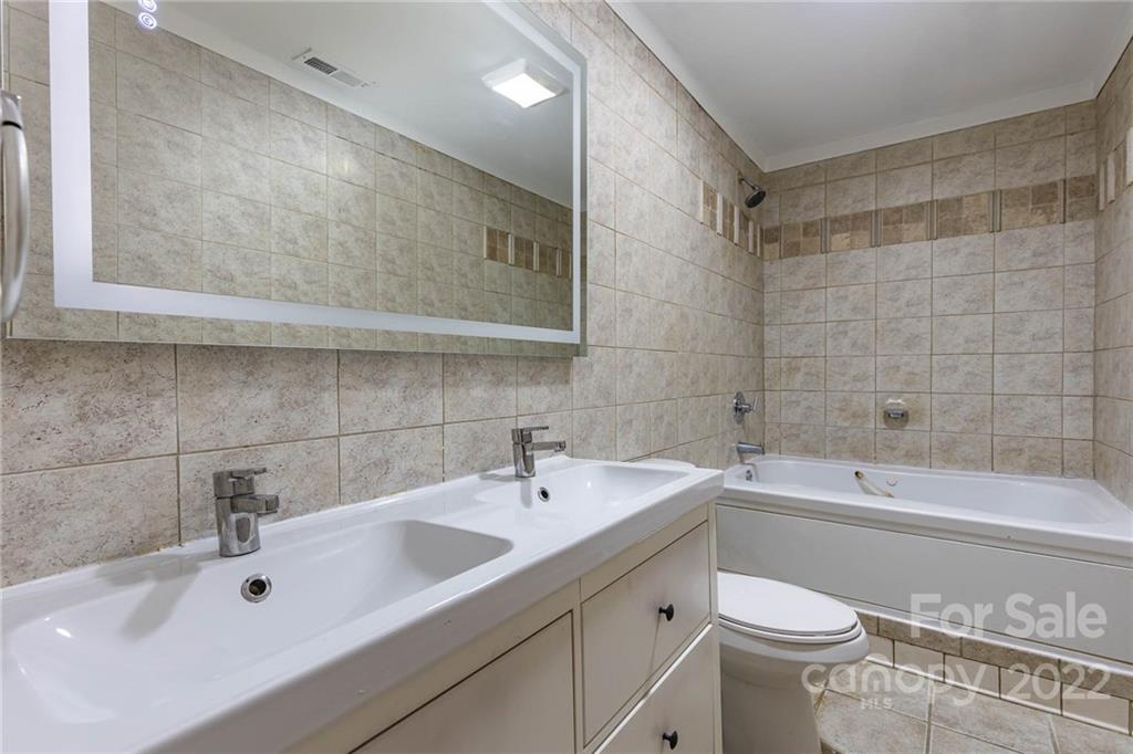 3415 Spring Terrace Lane Charlotte, NC 28269 - Photo 20 of 23 a bathroom with a sink a toilet and bathtub