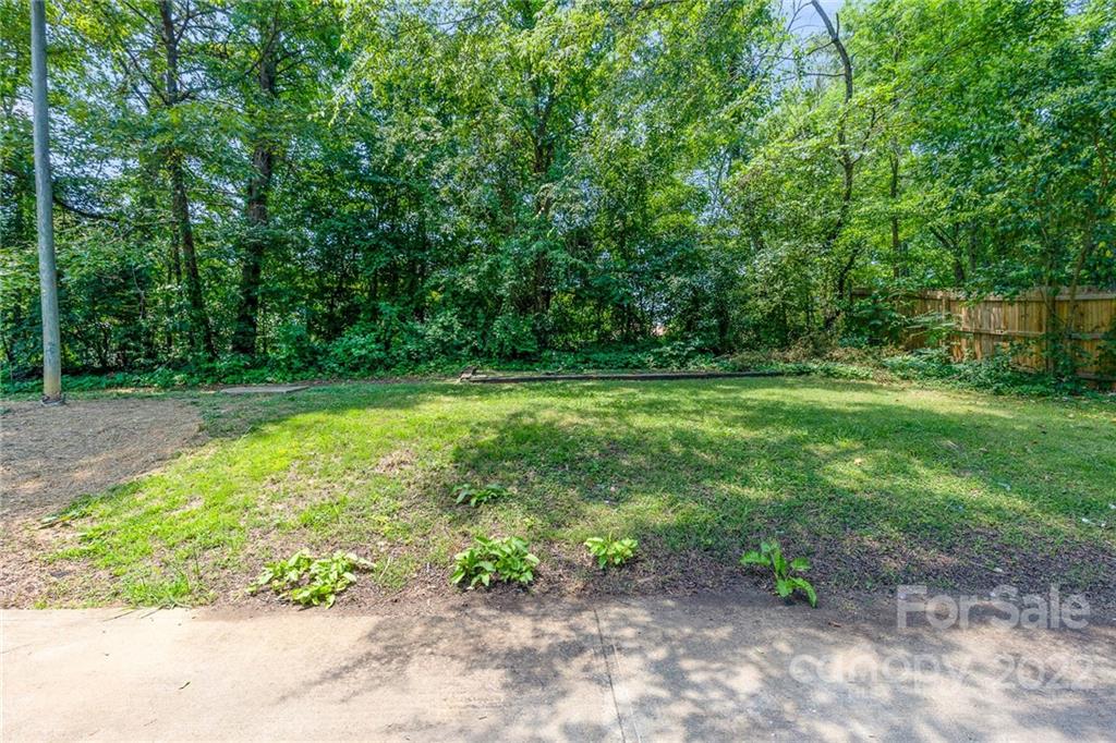 3415 Spring Terrace Lane Charlotte, NC 28269 - Photo 23 of 23 a view of a garden with a bench