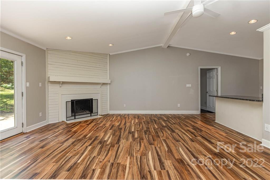3415 Spring Terrace Lane Charlotte, NC 28269 - Photo 5 of 23 a view of empty room with wooden floor and fireplace