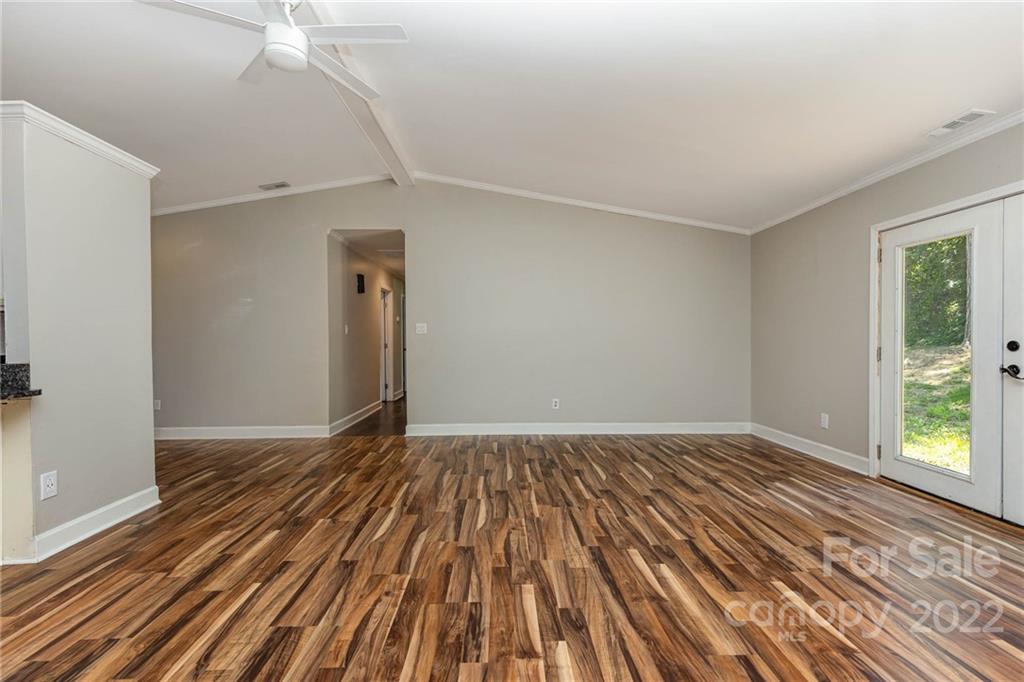3415 Spring Terrace Lane Charlotte, NC 28269 - Photo 6 of 23 a view of an empty room with wooden floor and a window