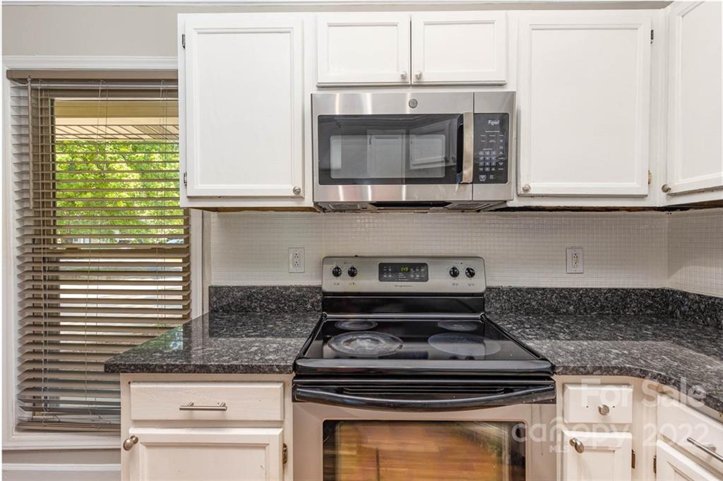 3415 Spring Terrace Lane Charlotte, NC 28269 - Photo 10 of 23 a stove top oven sitting inside of a kitchen