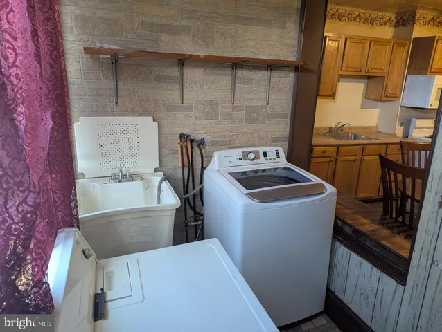 a kitchen with kitchen island a stove and a refrigerator