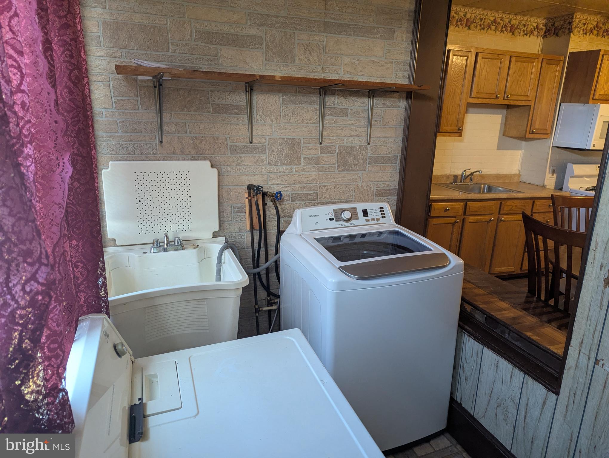 3442 Belair Road Baltimore, MD 21213 - Photo 19 of 27 a utility room with dryer washer and empty racks