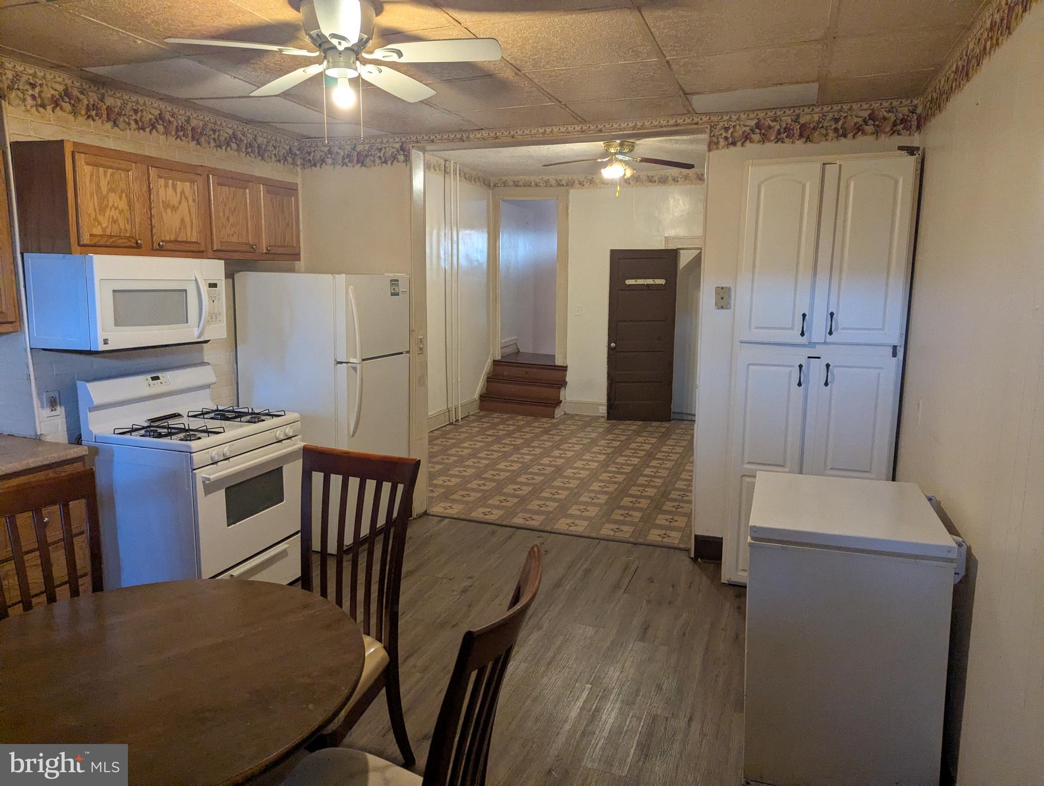 3442 Belair Road Baltimore, MD 21213 - Photo 20 of 27 a kitchen with kitchen island a stove and a refrigerator