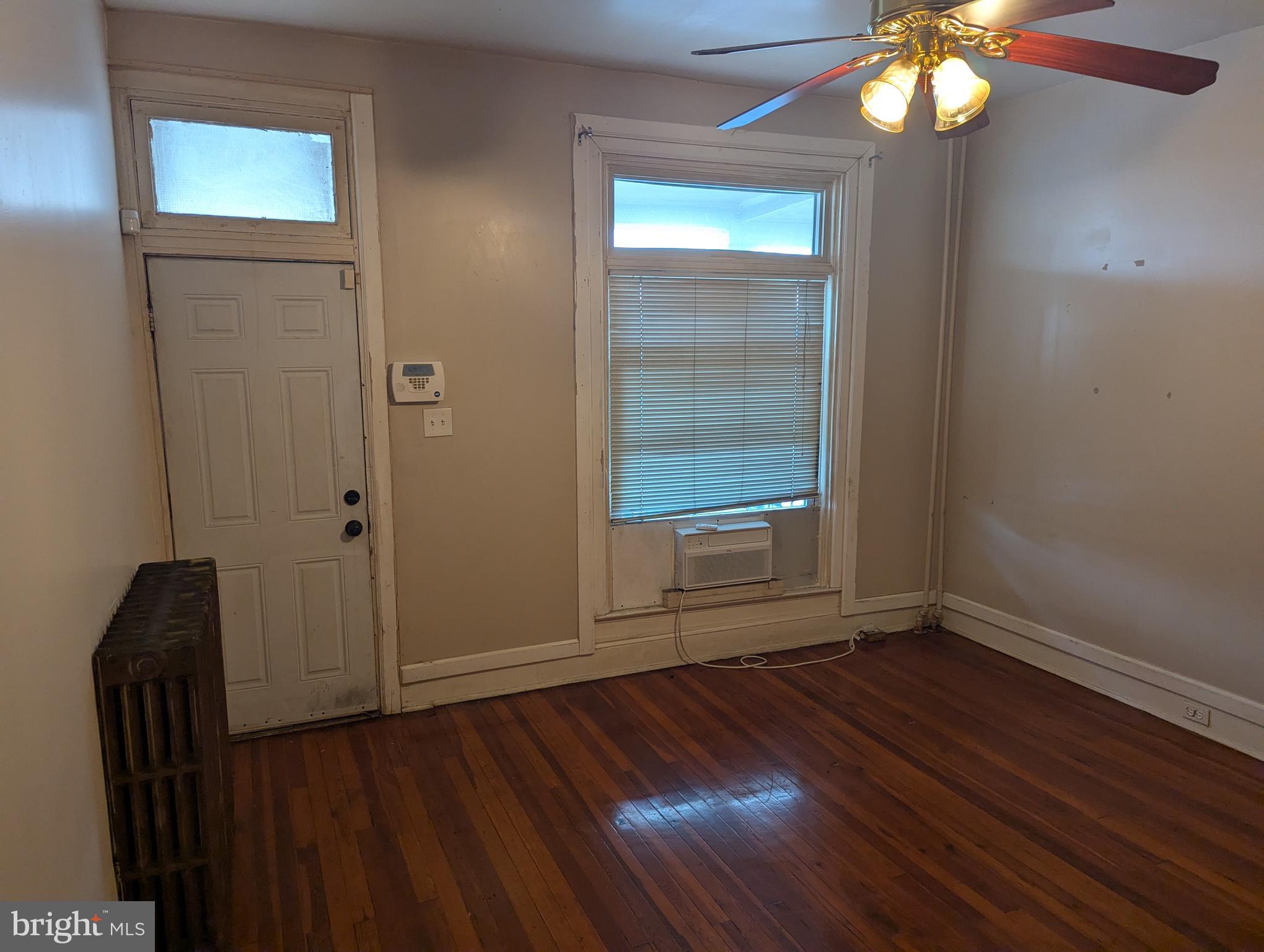 3442 Belair Road Baltimore, MD 21213 - Photo 3 of 27 a view of an empty room with wooden floor and a window