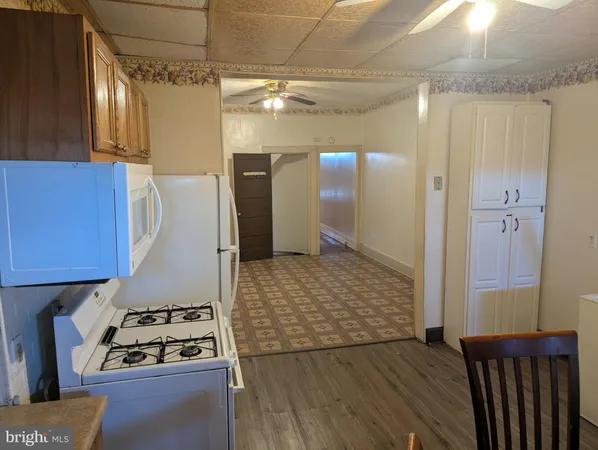 a kitchen with granite countertop a refrigerator and a stove