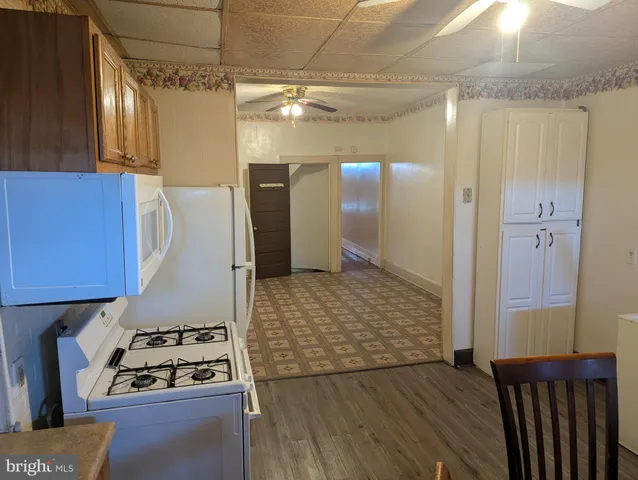 a kitchen with granite countertop a refrigerator and a stove