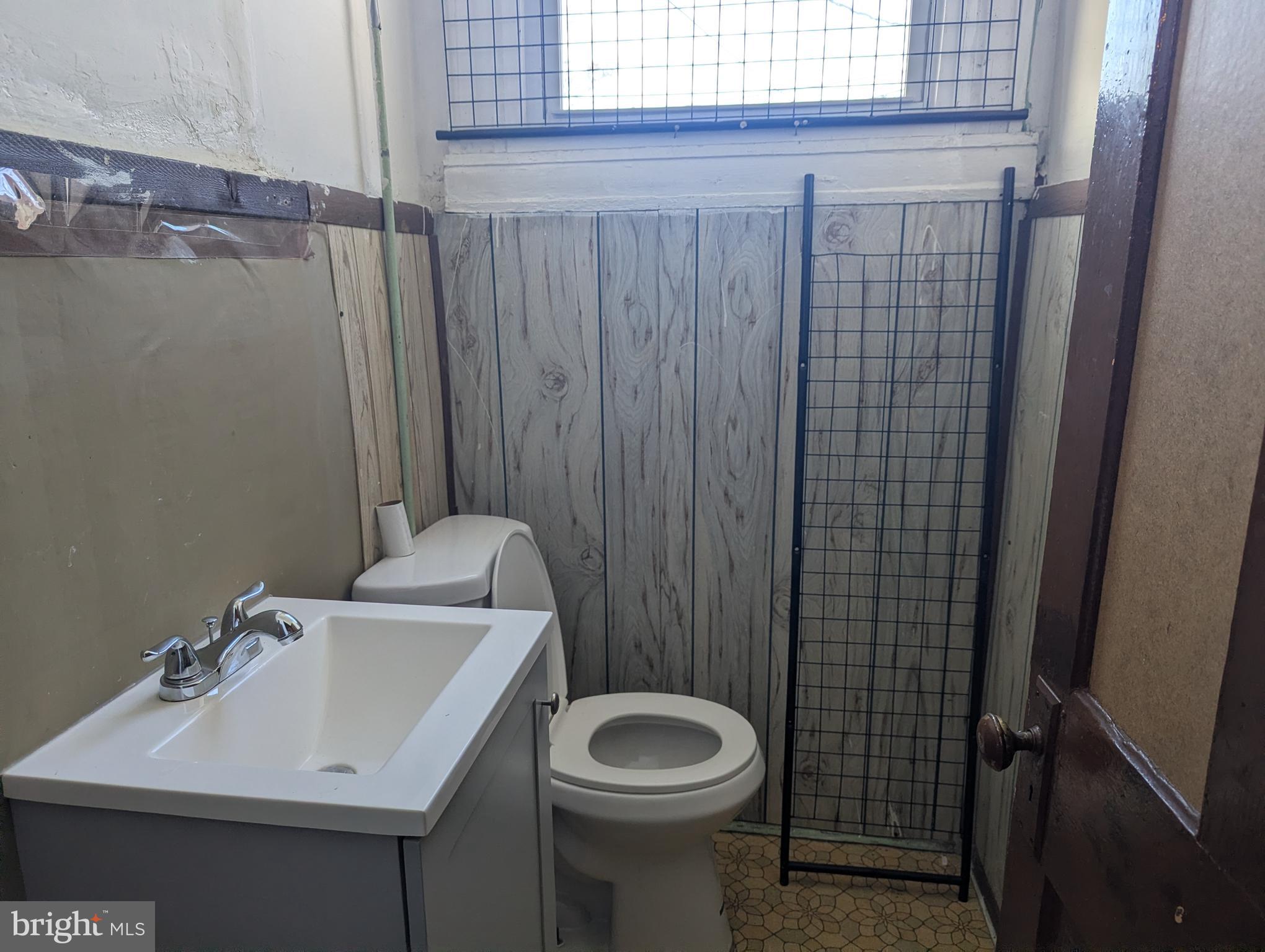 3442 Belair Road Baltimore, MD 21213 - Photo 9 of 27 a bathroom with a sink a toilet and shower