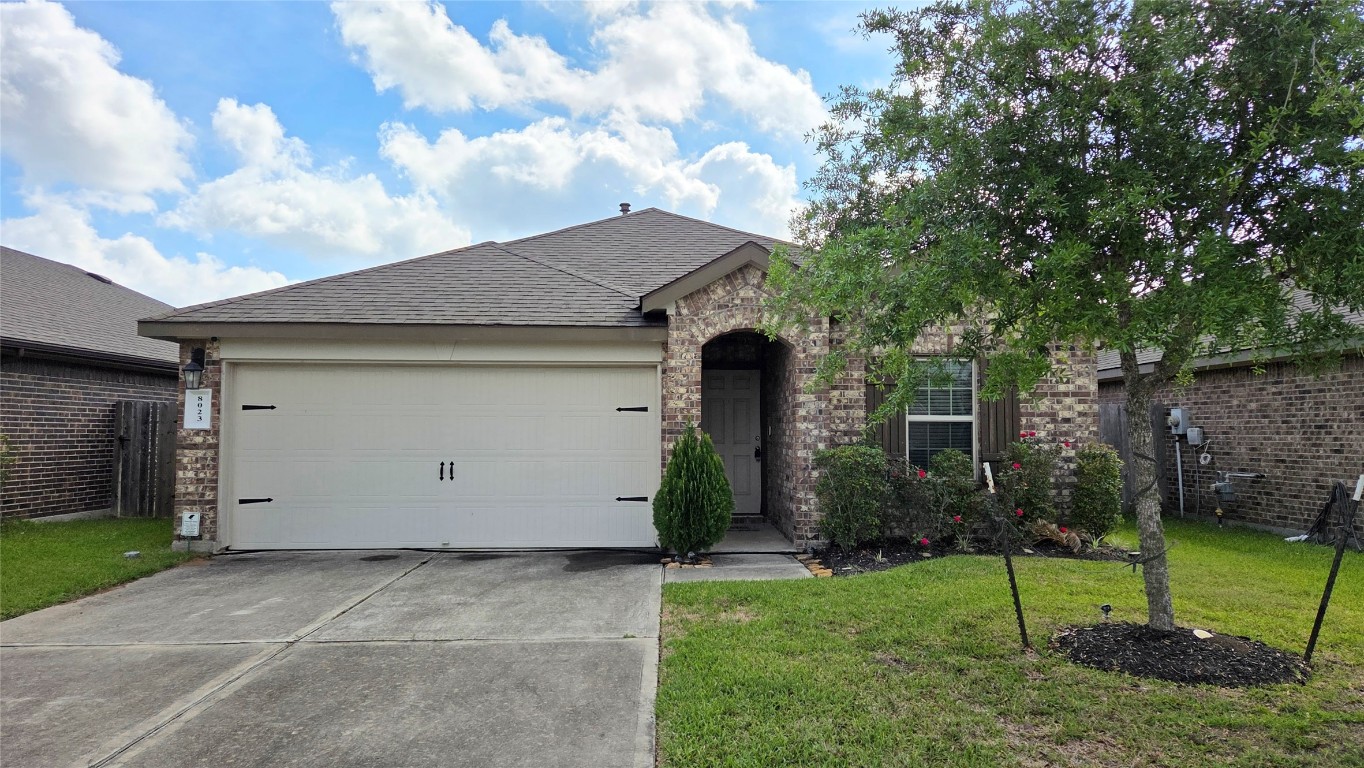 a view of backyard of house with green space