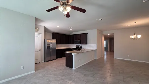a kitchen with stainless steel appliances granite countertop a stove and a refrigerator