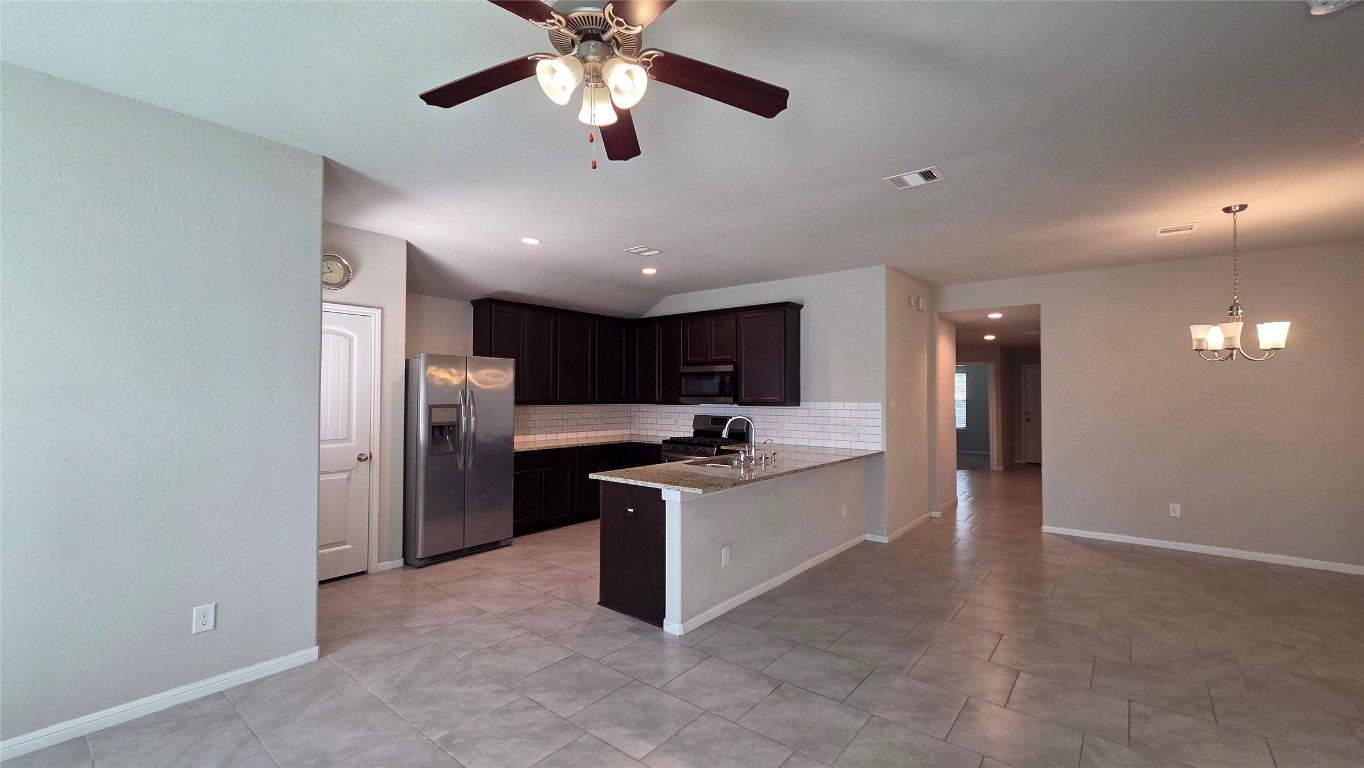 8023 Ecru Lane Rosharon, TX 77583 - Photo 4 of 10 a kitchen with stainless steel appliances granite countertop a stove and a refrigerator