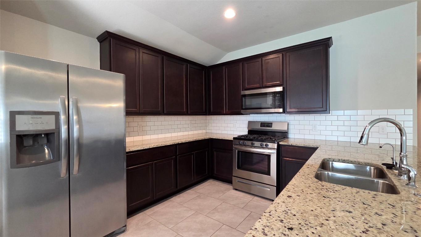 8023 Ecru Lane Rosharon, TX 77583 - Photo 5 of 10 a kitchen with stainless steel appliances granite countertop a refrigerator stove a sink and dishwasher