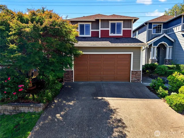 a front view of a house with a yard and garage