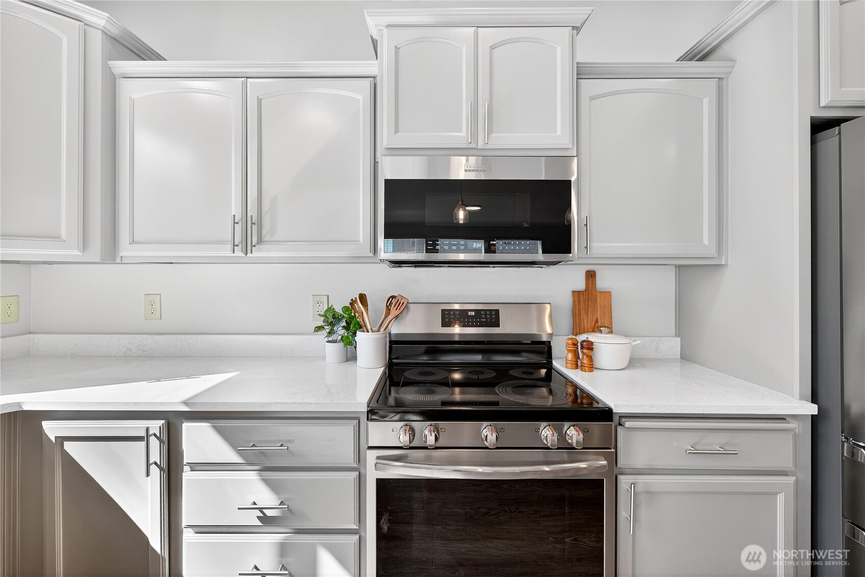 25621 160th Place Southeast Covington, WA 98042 - Photo 27 of 37 a kitchen with white cabinets and a stove top oven