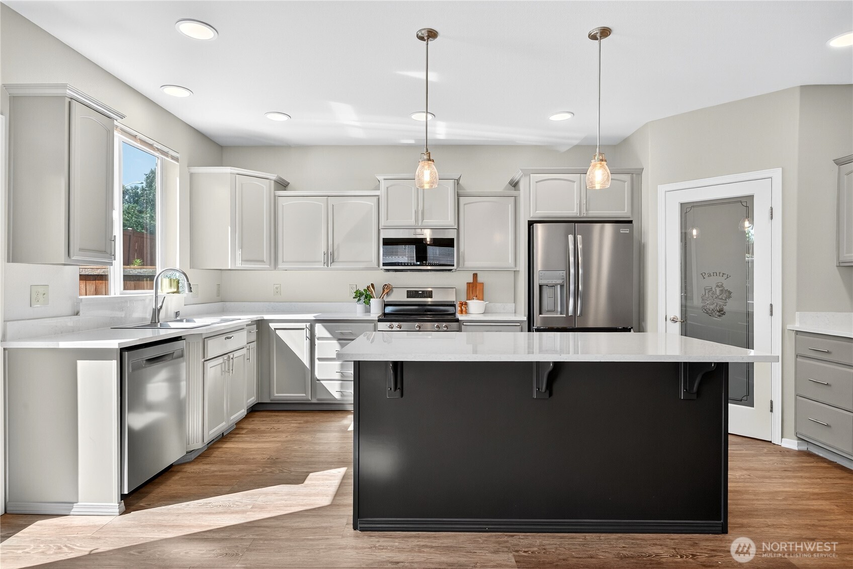 25621 160th Place Southeast Covington, WA 98042 - Photo 28 of 37 a kitchen with stainless steel appliances granite countertop a sink a stove a refrigerator a center island and cabinets