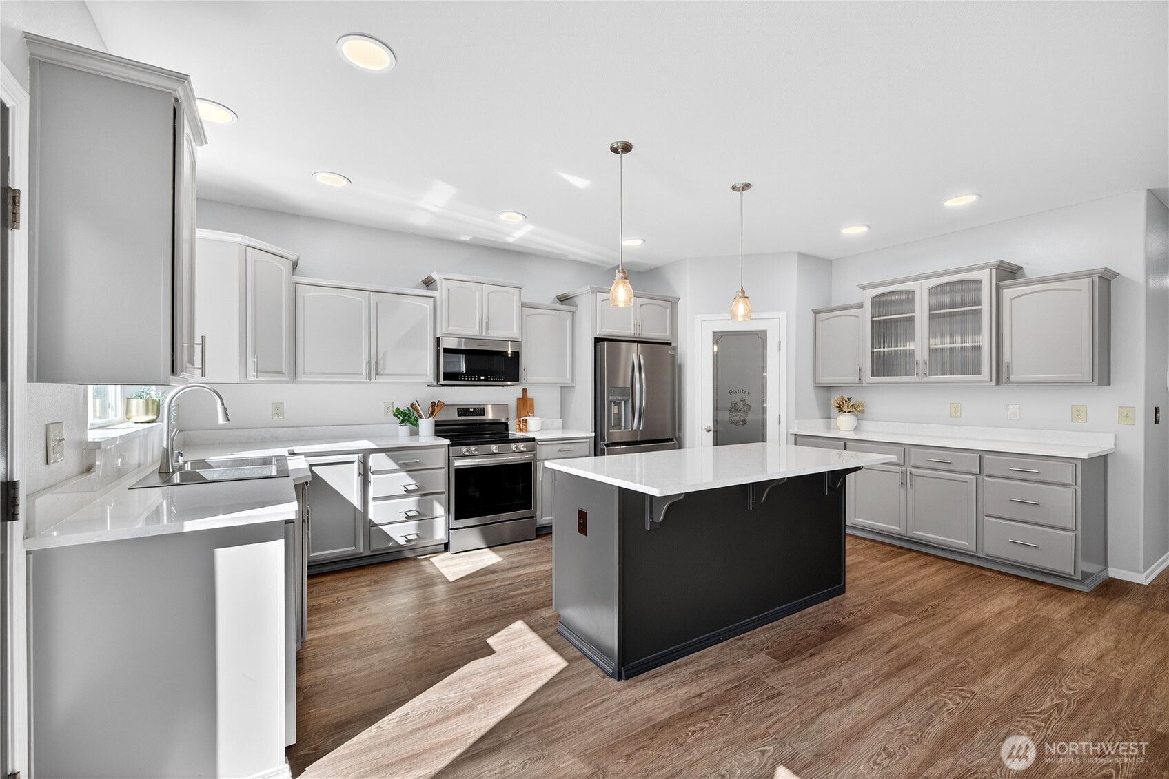 25621 160th Place Southeast Covington, WA 98042 - Photo 4 of 37 a large kitchen with stainless steel appliances kitchen island granite countertop a stove and a sink
