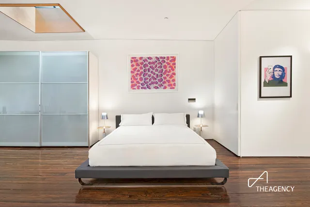 a spacious bathroom with a bathtub and a wooden floor