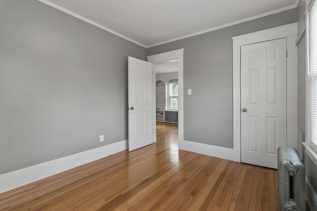 69 Redlands Street Springfield, MA 01104 - Photo 11 of 29 a view of an empty room and wooden floor