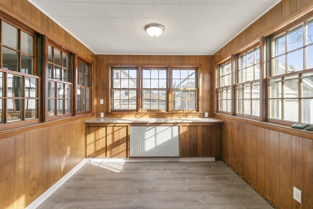 69 Redlands Street Springfield, MA 01104 - Photo 20 of 29 a large white kitchen with granite countertop a stove a sink and a large window