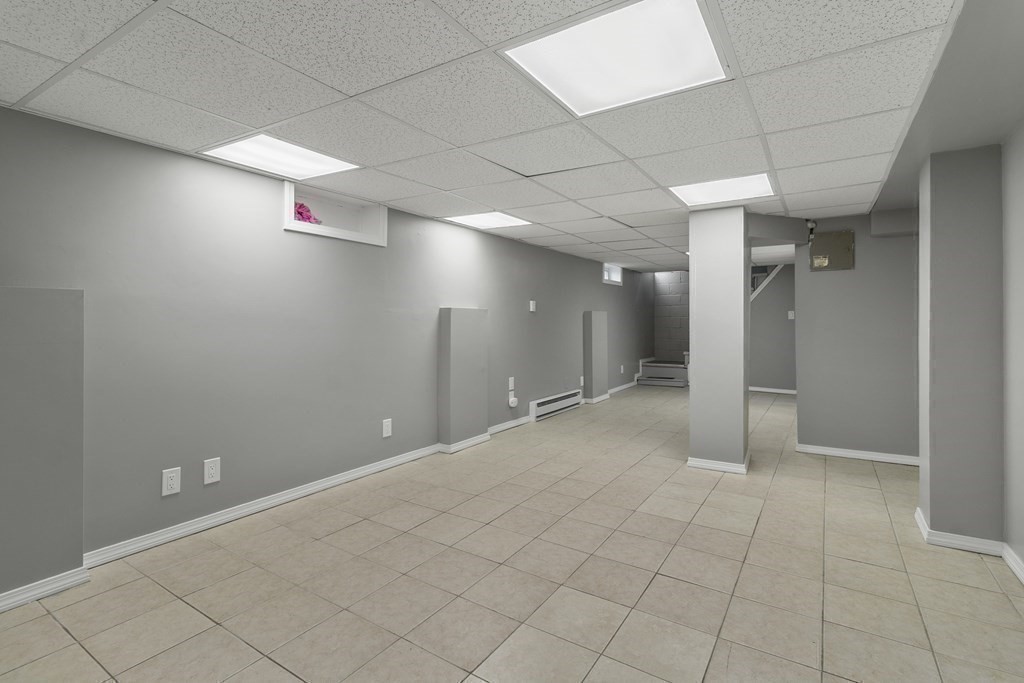 69 Redlands Street Springfield, MA 01104 - Photo 23 of 29 an empty room with white walls and tiles