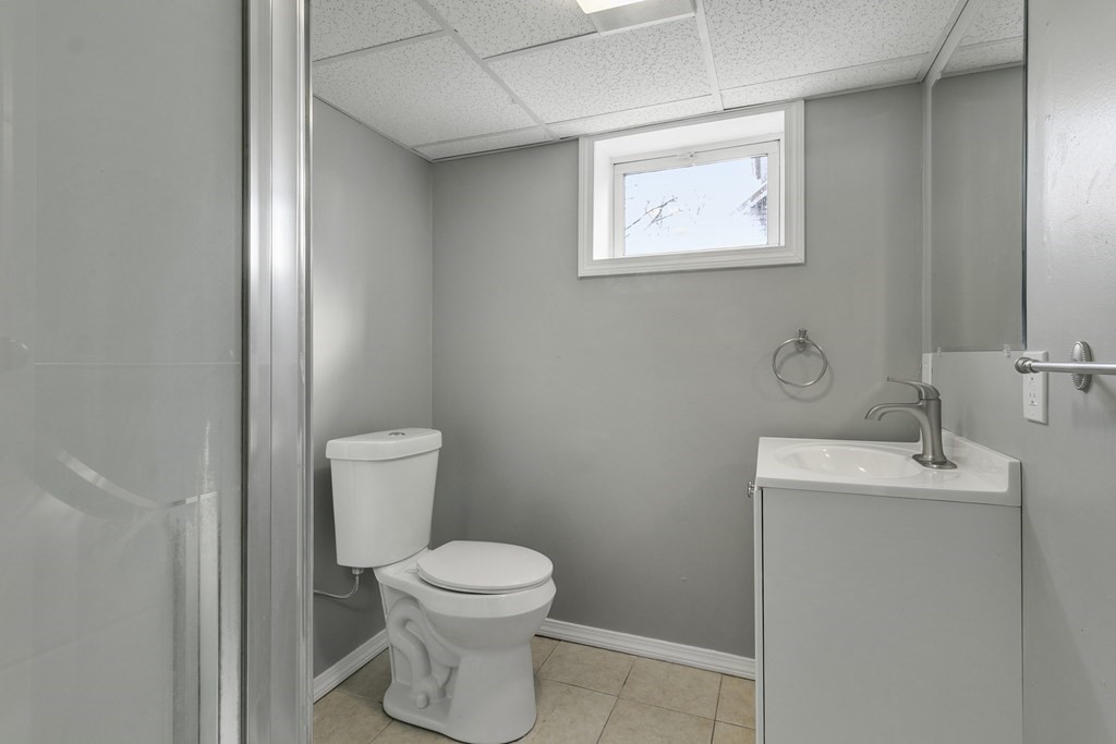 69 Redlands Street Springfield, MA 01104 - Photo 28 of 29 a white toilet sitting next to a bathroom sink