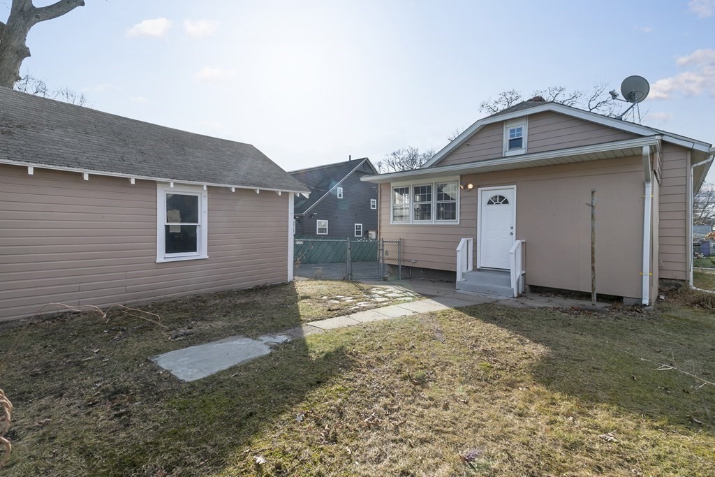 69 Redlands Street Springfield, MA 01104 - Photo 3 of 29 a front view of a house with a yard
