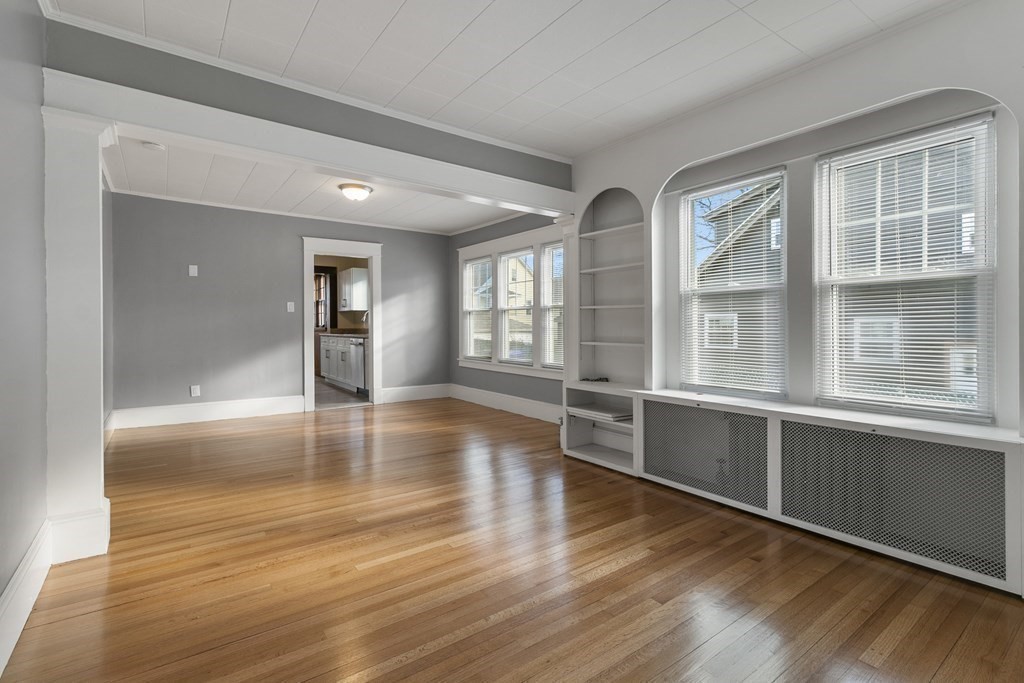 69 Redlands Street Springfield, MA 01104 - Photo 5 of 29 wooden floor in an empty room with a window