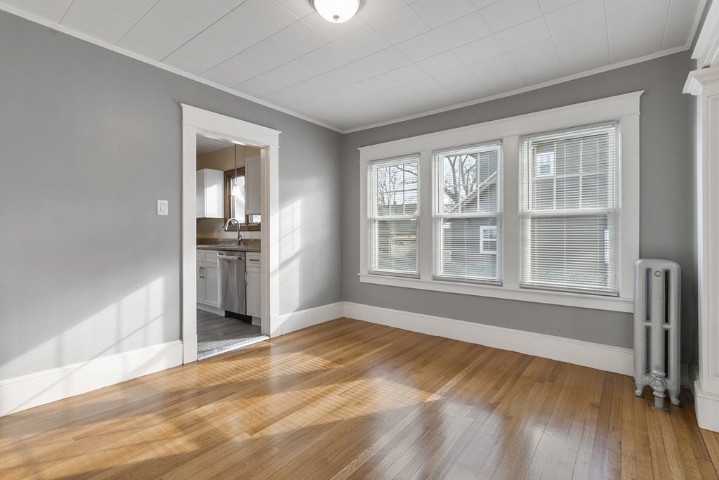 69 Redlands Street Springfield, MA 01104 - Photo 8 of 29 wooden floor in an empty room with a window