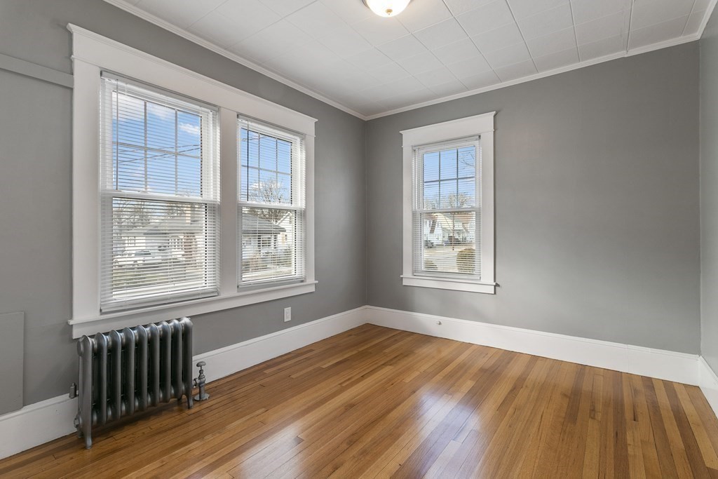 69 Redlands Street Springfield, MA 01104 - Photo 10 of 29 a view of an empty room with wooden floor and a window