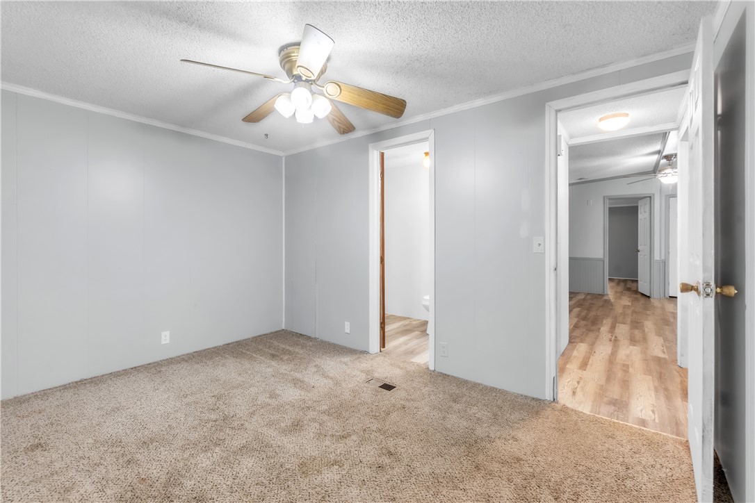 178 Childress Road Pickens, SC 29671 - Photo 18 of 32 A comfortable bedroom with soft carpeting offers a peaceful retreat with a practical ceiling fan.