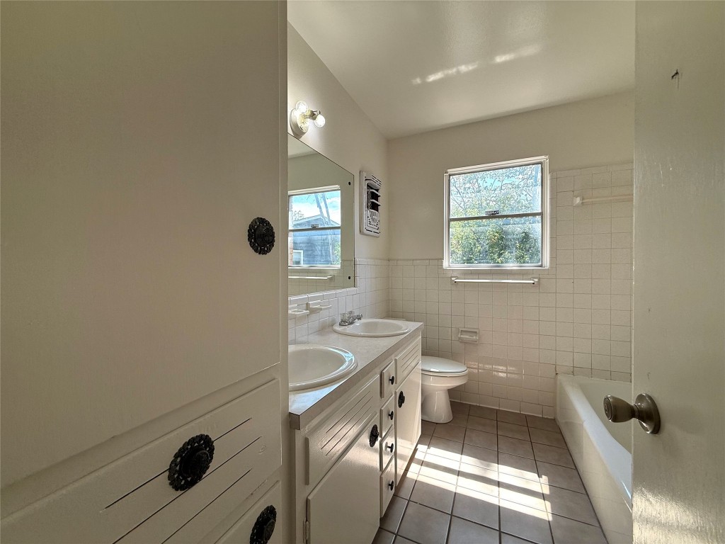 2711 Little John Lane Austin, TX 78704 - Photo 12 of 30 a bathroom with a sink a toilet and shower