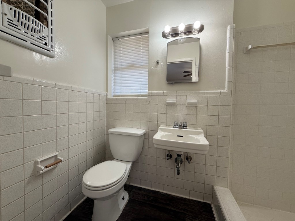2711 Little John Lane Austin, TX 78704 - Photo 16 of 30 a bathroom with a toilet a sink and mirror