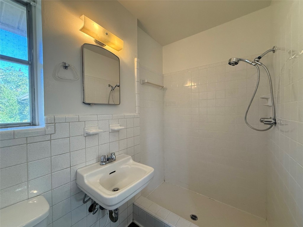 2711 Little John Lane Austin, TX 78704 - Photo 17 of 30 a bathroom with a sink a toilet and shower