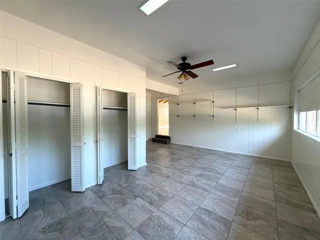 a view of a livingroom with a ceiling fan and window