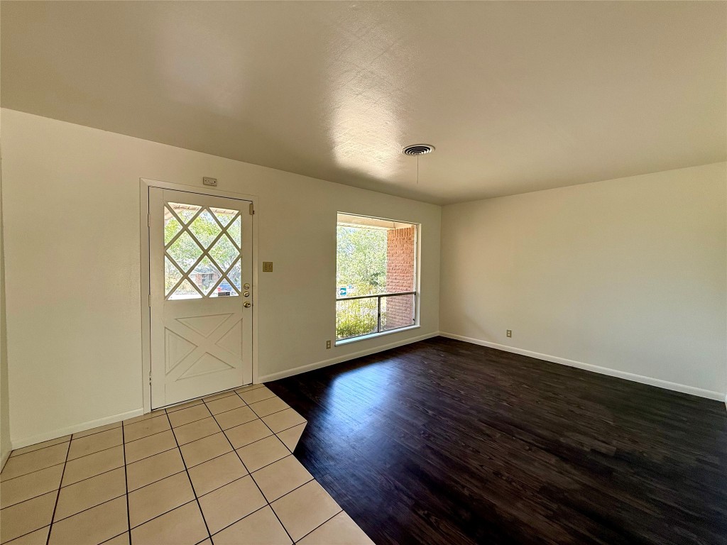 2711 Little John Lane Austin, TX 78704 - Photo 3 of 30 an empty room with wooden floor and windows