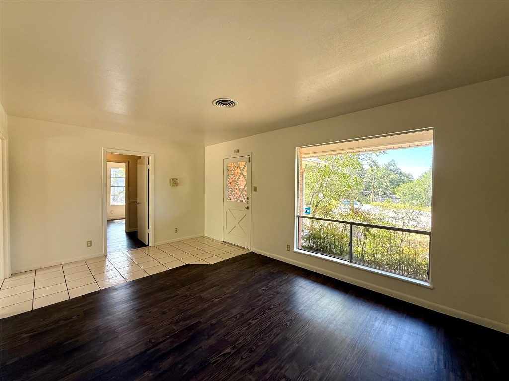 2711 Little John Lane Austin, TX 78704 - Photo 4 of 30 an empty room with wooden floor and windows