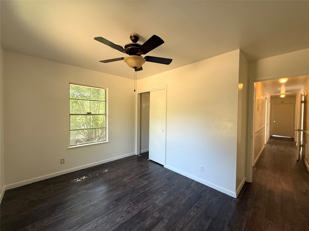 2711 Little John Lane Austin, TX 78704 - Photo 10 of 30 a view of an empty room with wooden floor and a window