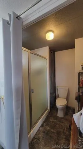 a bathroom with a toilet and a shower